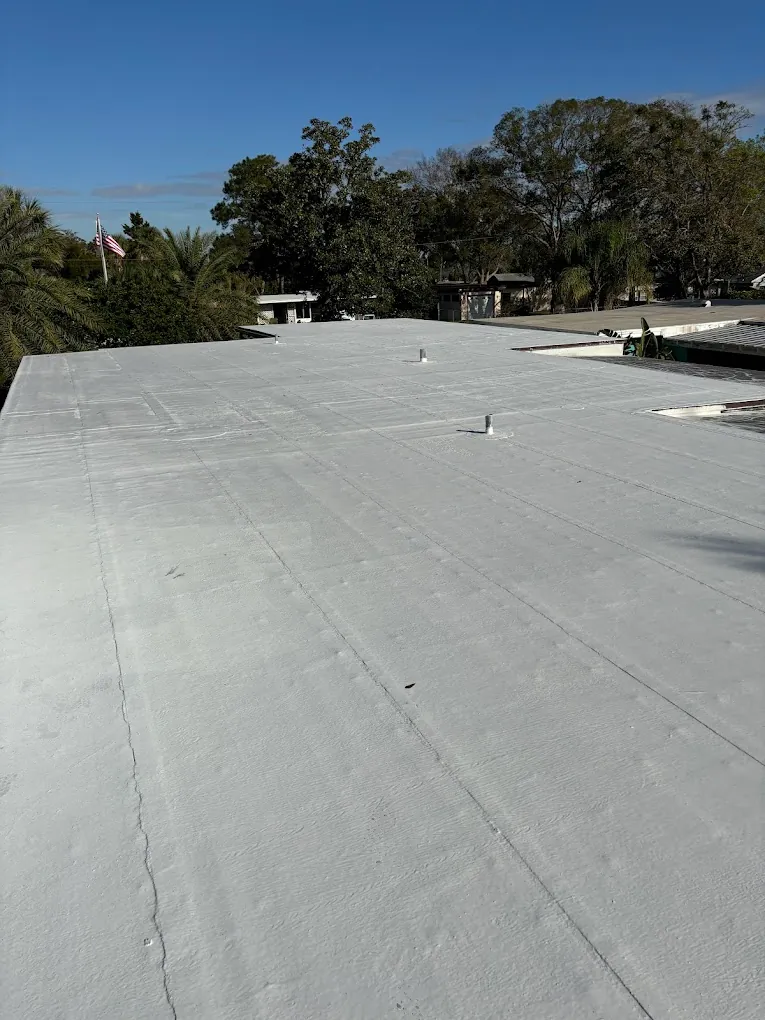 Wide view of a light-colored low-slope roof surface.