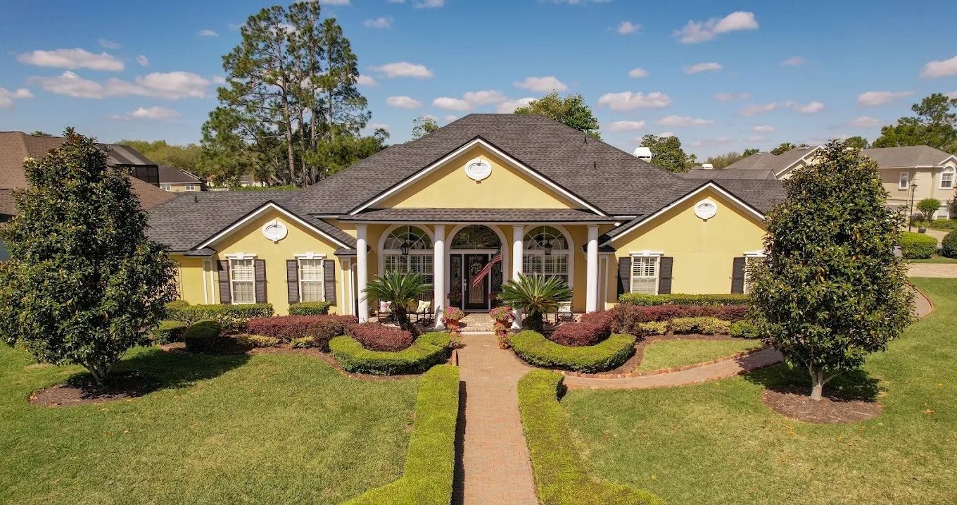 Front view of a home with a gray shingle roof.